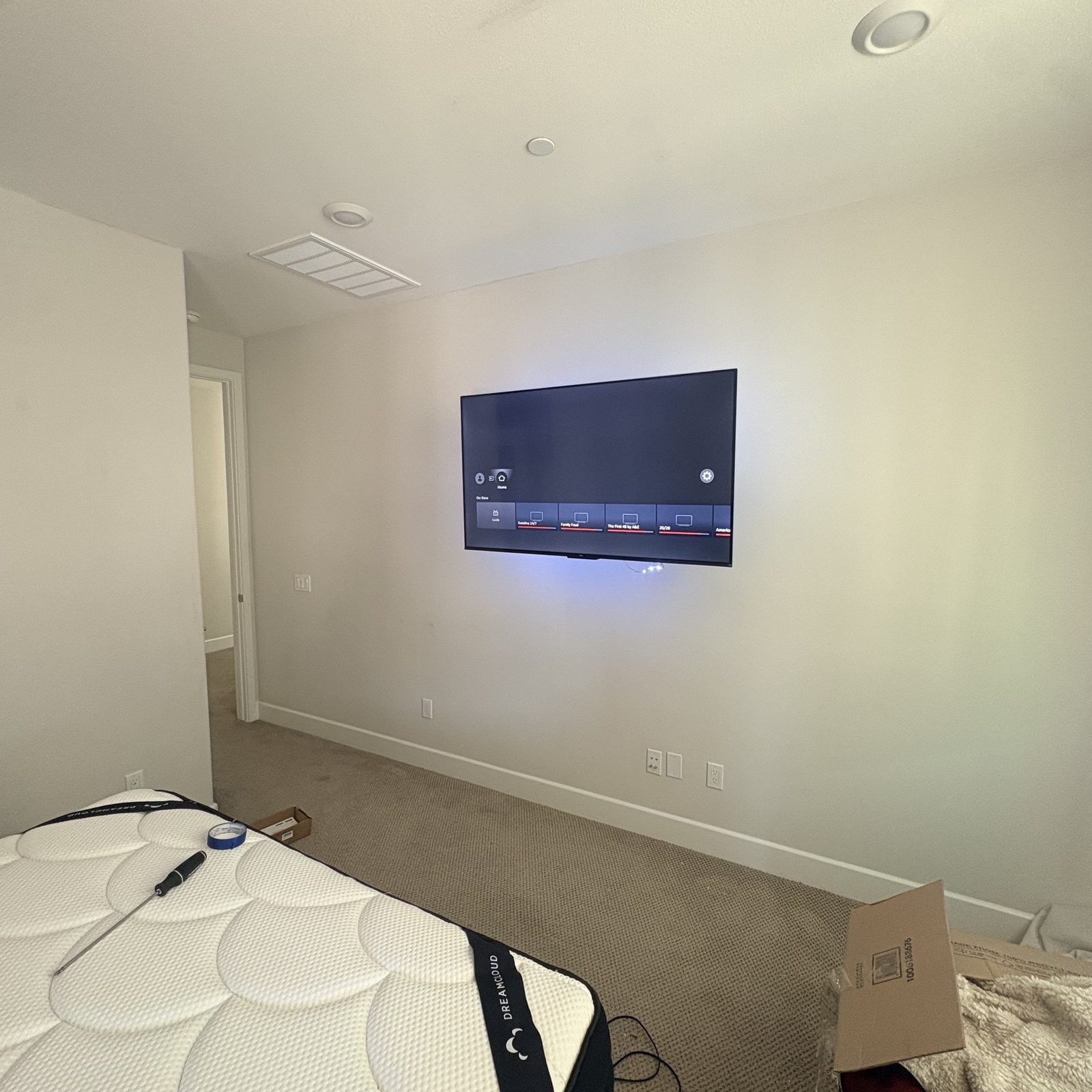 Wall-mounted TV in bedroom during move-in
