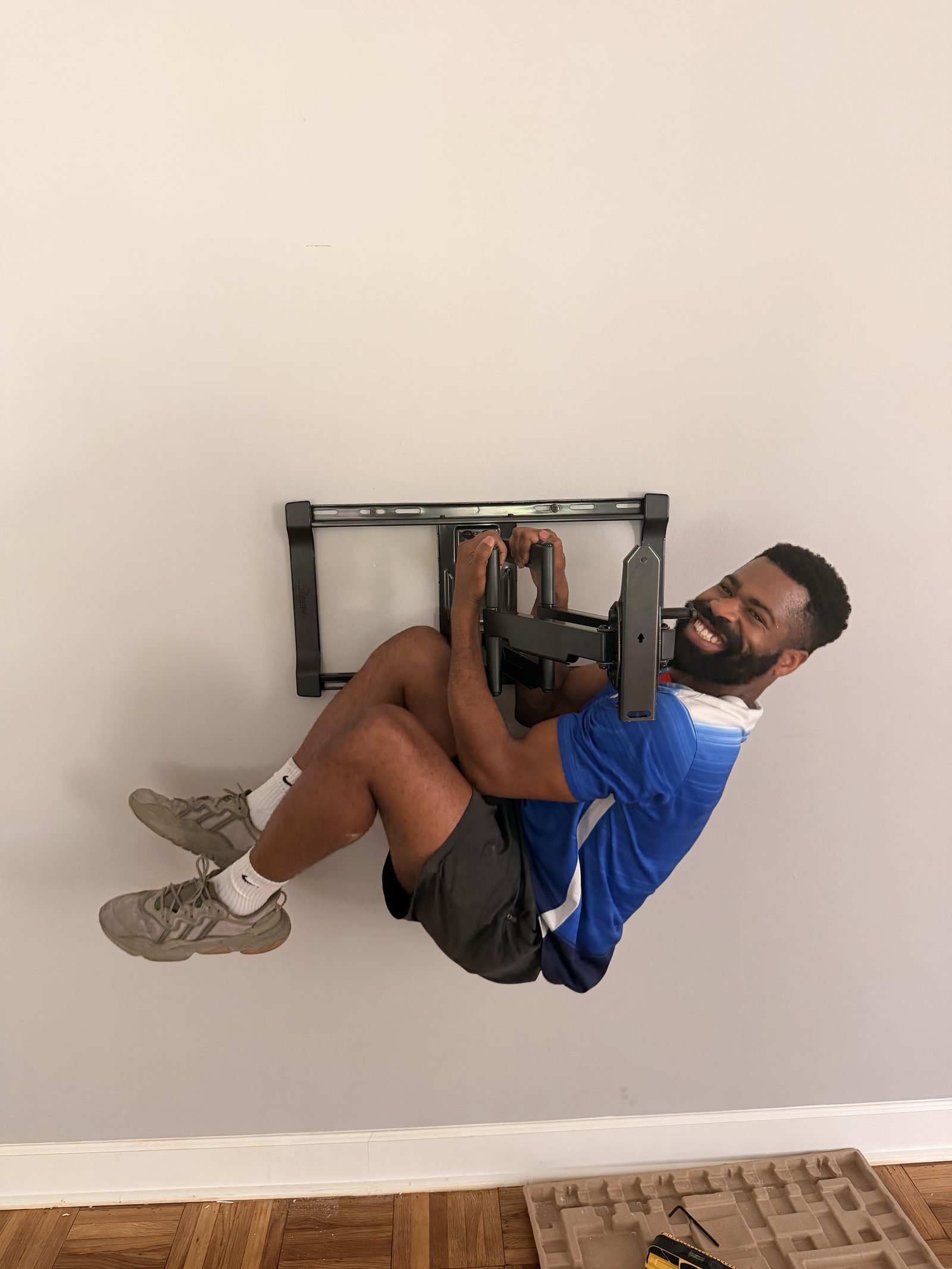 Ike installing a full-motion articulating TV wall mount